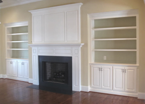  wood burning fireplace with gas logs installed and built-in bookcases